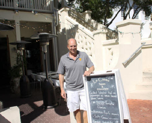 Kevin Neel, owner of La Crema poses in front of restaurant at Rosemary Beach, Florida