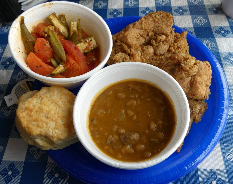 Fried chicken wth sides of okra and tomatoes, beans, and a bisquit 