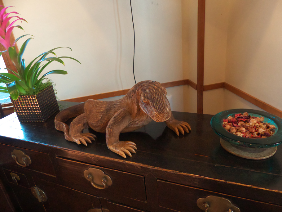 a detailed lizard sculpture on sideboard in lobbly at Dinah's Garden Hotel