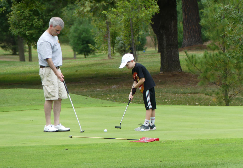 Boy and man playing golf  at Capon Springs