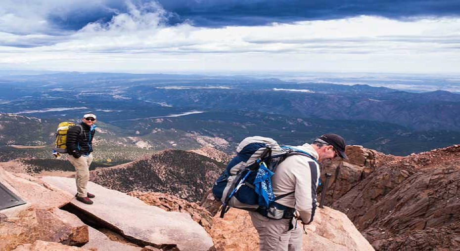 Two hikers at summit of Pikes Peak