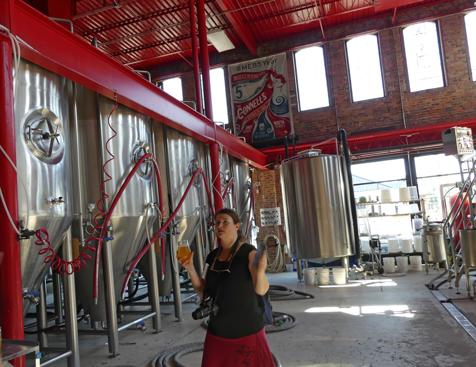 Visitor admiring Mother Earth Brewery tanks.