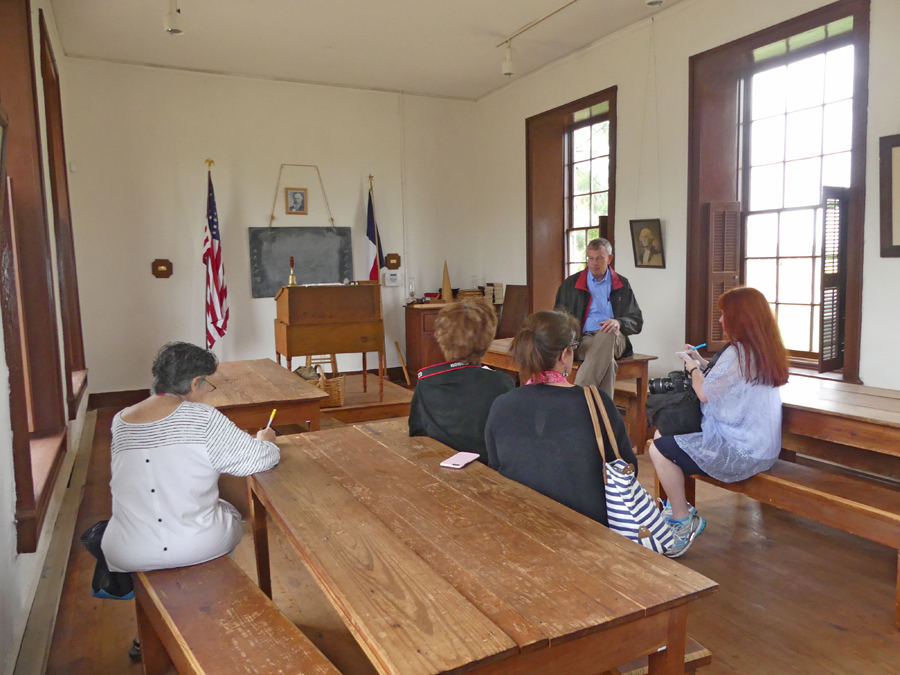 The chapel/schoolroom at Fort Concho with peopel sitting in it