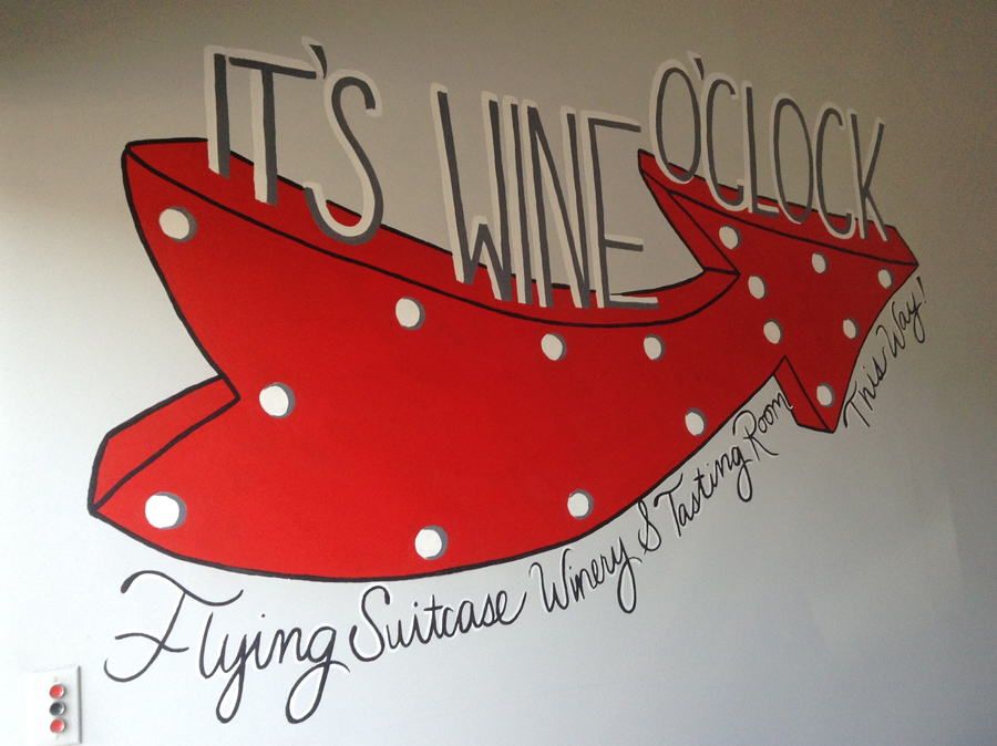 colorful arrow point with text It's Wine o:clock and Flying Suitcase Winery
