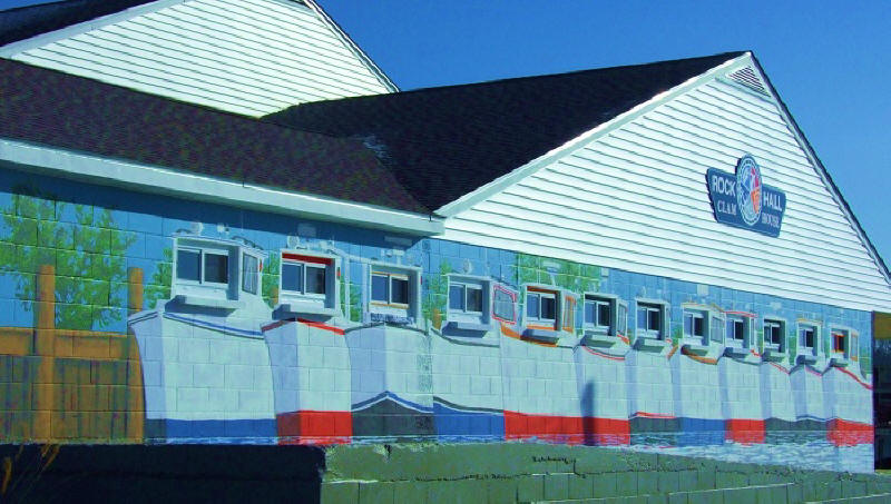 images of work boats jostling beside each other on the sides of a former seafood processing plant