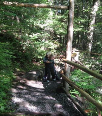 Hugging a child on trail near Natural Stone Bridge and Caves in Pottersville, New York