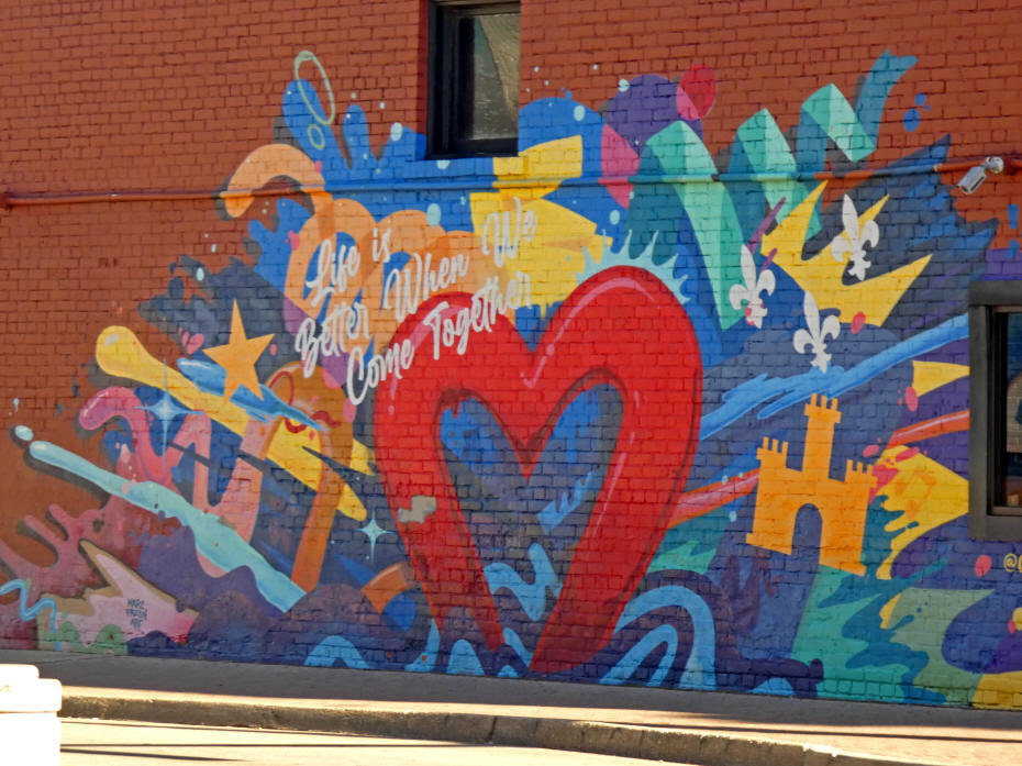 mural wiht bright red heart sayingLife is better when we come together
