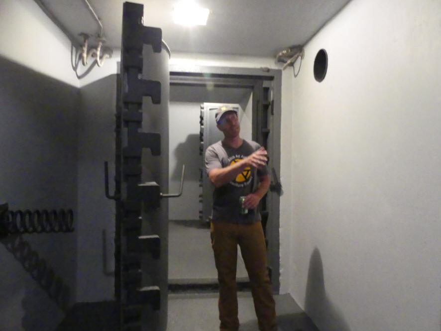 man entering vault doors in silo