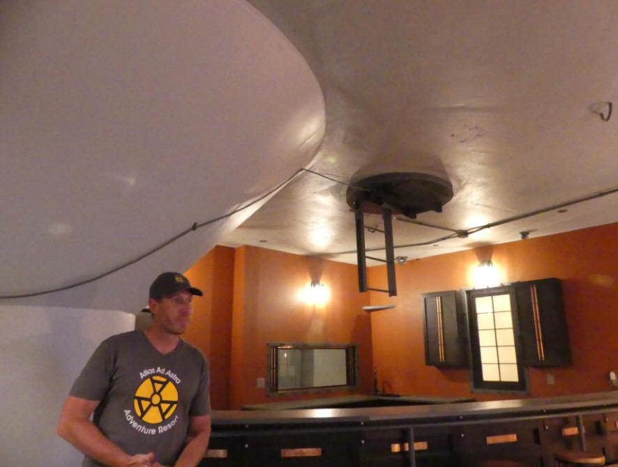 matthew in kitchen area of silo wiht escape hatch laddder showing