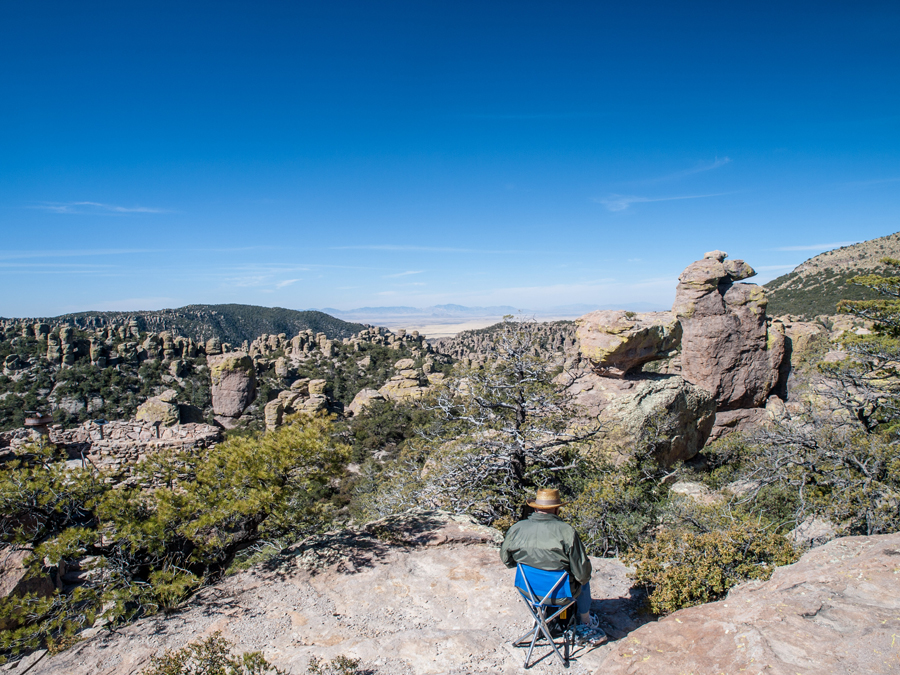 Man siting on chair looking at mountains in Willcox Arizona