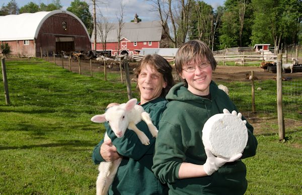 owners of Nettle Meadow Farm holding goast and cheese