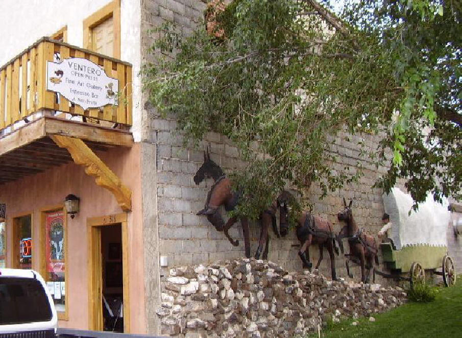 3-D Mural on the side of Ventero's building in San Luis, CO. of conostoga wagon pulled by team of horses