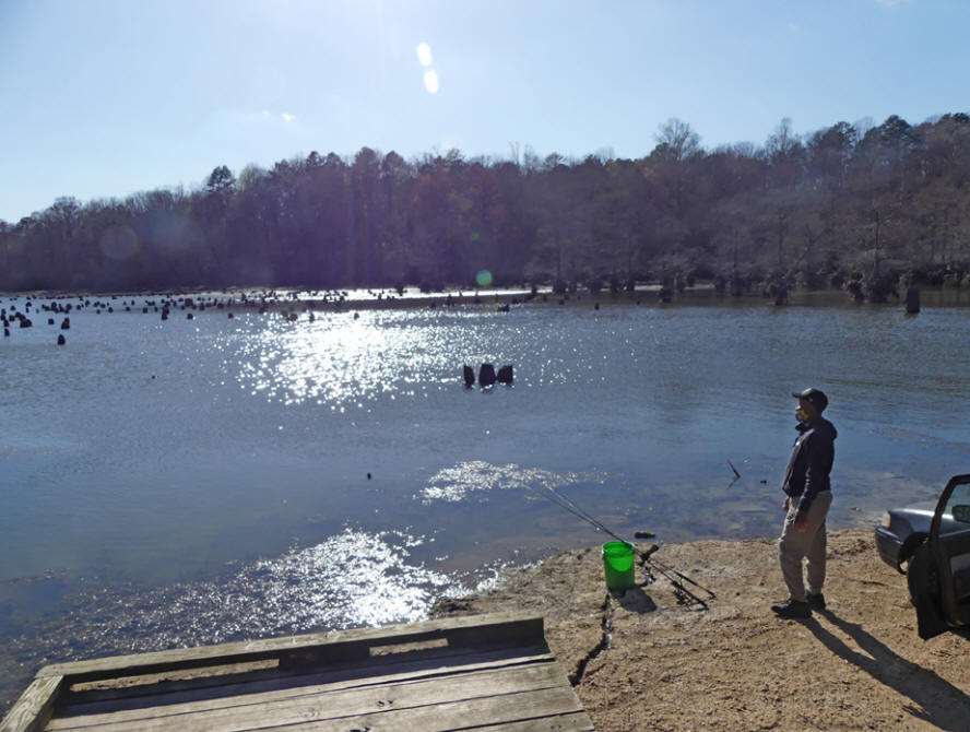 fisherman tries his luck at Wall doxey's lake