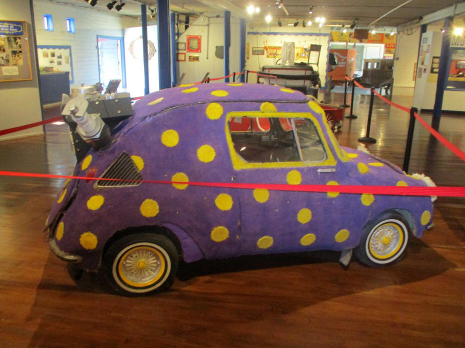 purple car with yellow dots