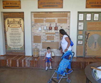 mother and child look at exhibit at St. Augustine Distillery museum