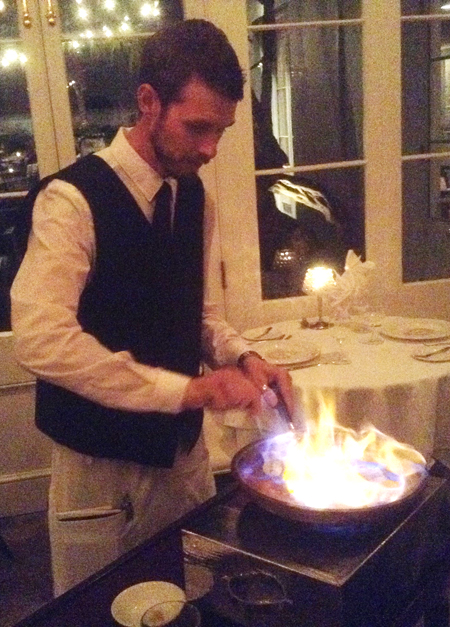 Waiter creating Bananas Foster at Broussard’s Restaurant in New Orleans