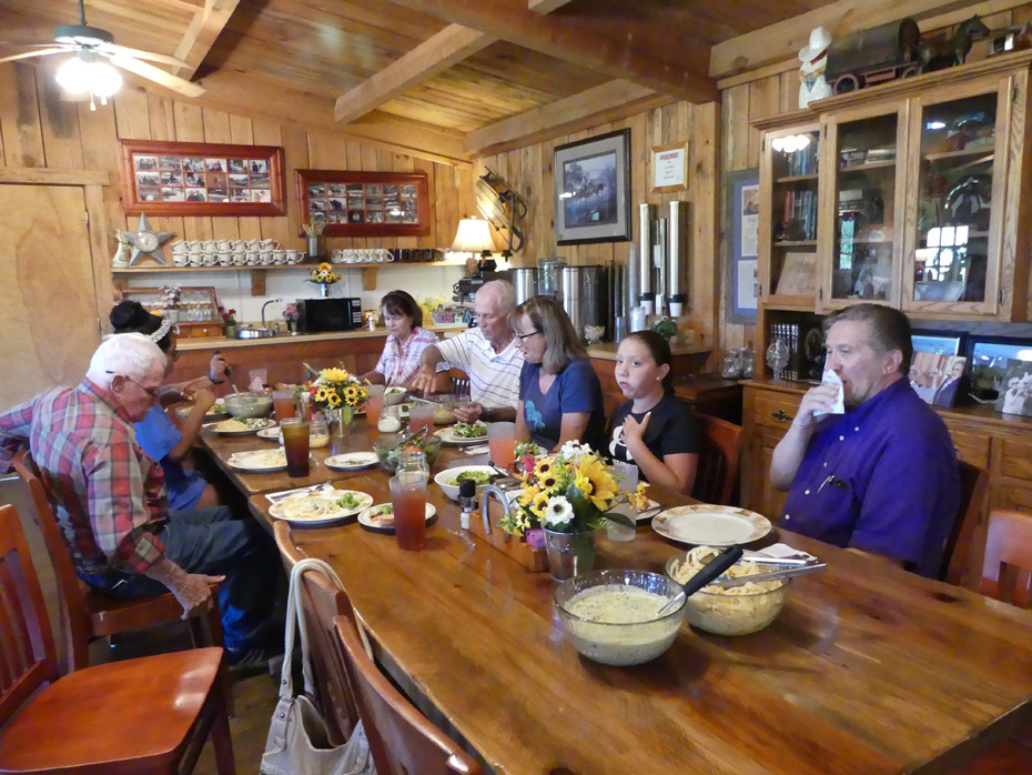 people at a long table dining at French Broad Outpost Dude Ranch in Eastern Tennessee