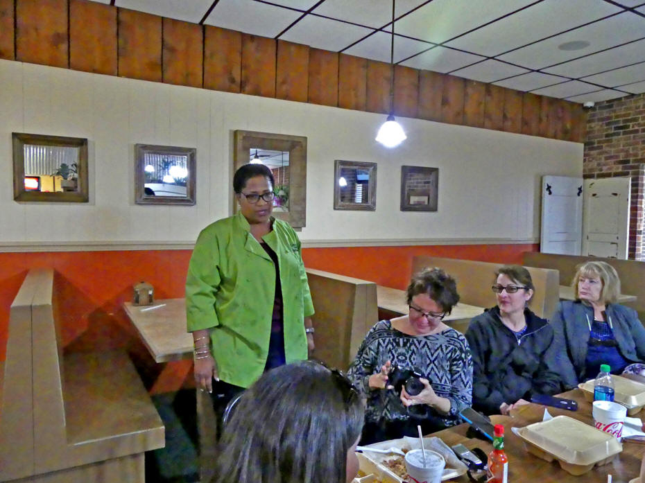 woman talking to other women at table