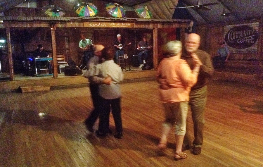 Cajun musicians playing at Randol's in Arcadiana while two couples dance