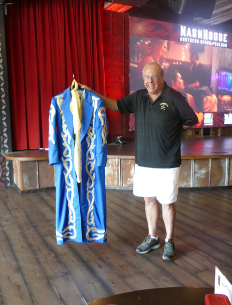 Man holding  Manuel costume on stage at Nashhouse Southern Spoon and Saloon