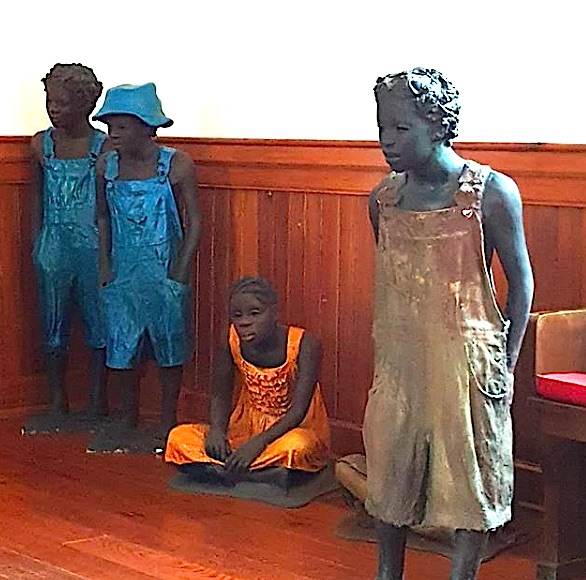 Life-sized sculptures of four enslaved children by Woodrow Nash