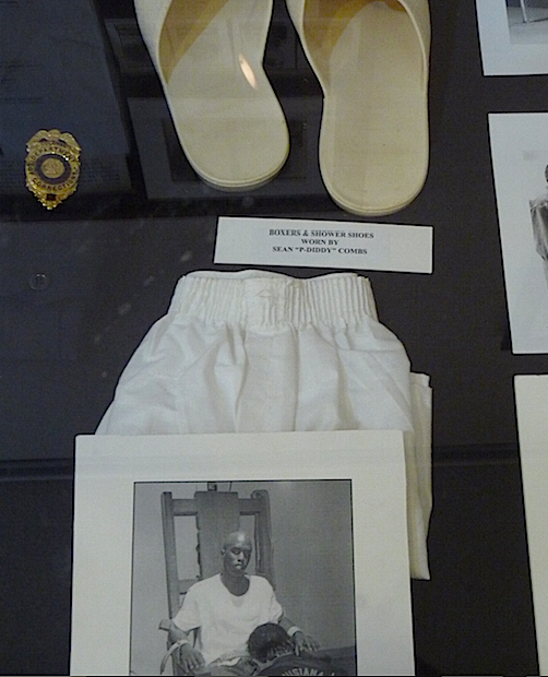 display of shower shoes, boxer shorts and photop of electric chair withman sitting in it