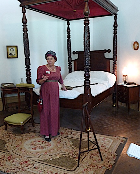 female guide in destrehen plantation bedroom