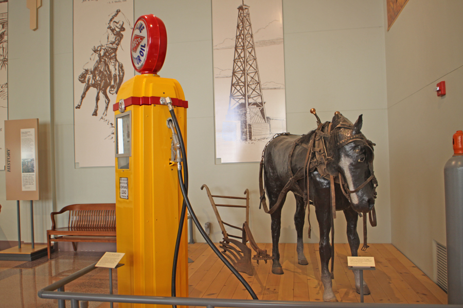 Exhibit showing a gas pump and a horse in Panhandle Plains Historical Museum in Canyon, Texa