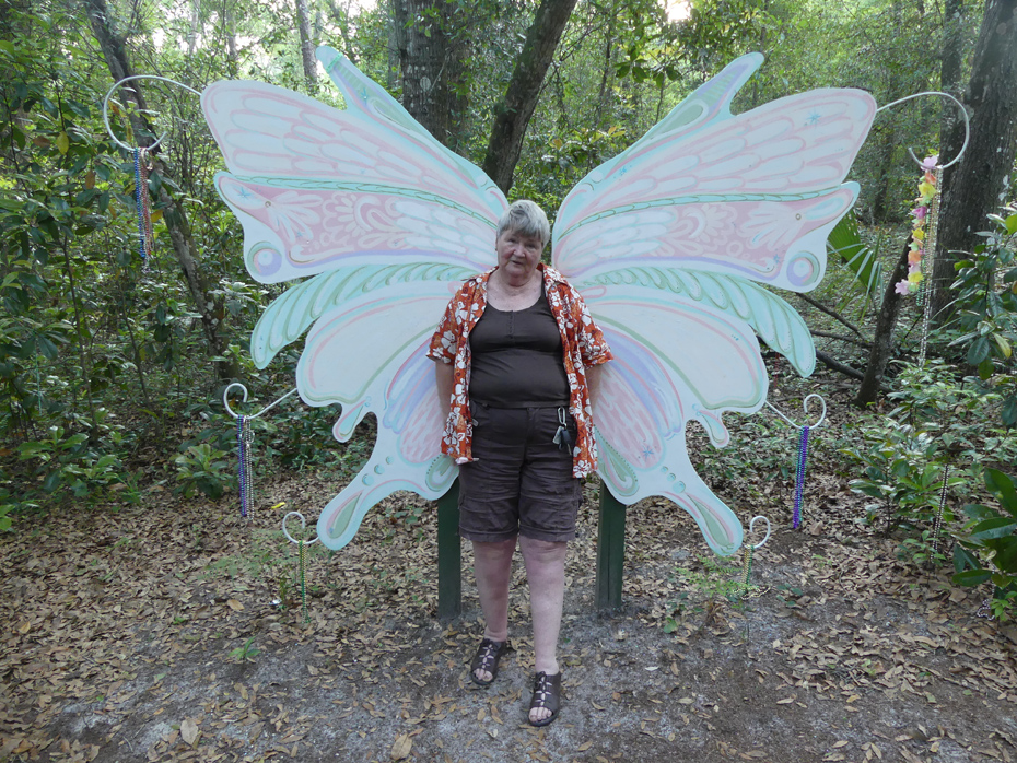 woman in front of wings