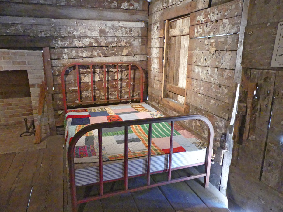 bed inside hewn timber cabin on Francis Marion University campus in Florence, SC