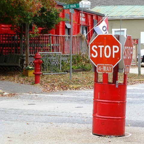 55 gallon drum painted red with a STOP sign affixed to the top in Rutledge, Georgia   