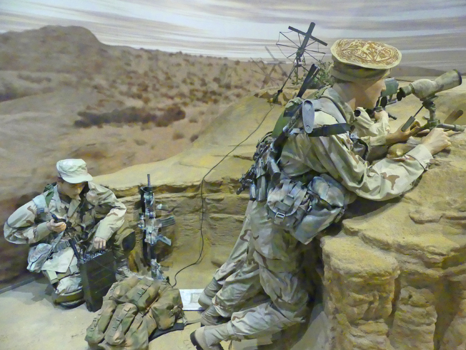 Exhibit of two soldiers in Afgan desert doing battle